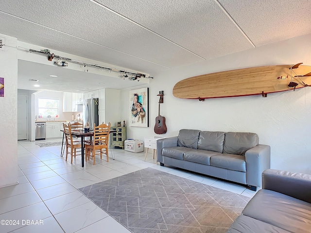 1510 Ocean Shore Blvd Unit 406, Ormond Beach, FL 32176 - living area featuring track lighting, a textured ceiling, and light tile patterned floors