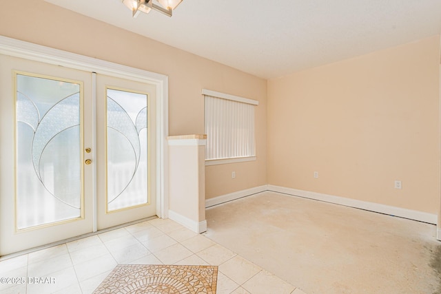 tiled foyer featuring french doors and a healthy amount of sunlight