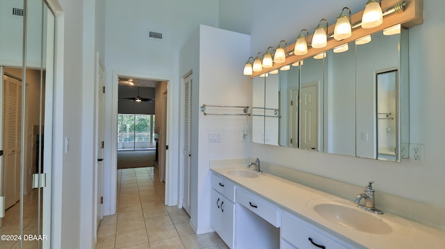 bathroom with tile patterned flooring, vanity, and ceiling fan