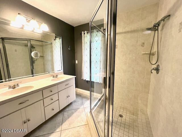 bathroom featuring tile patterned flooring, vanity, and an enclosed shower