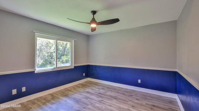 empty room with ceiling fan and wood-type flooring