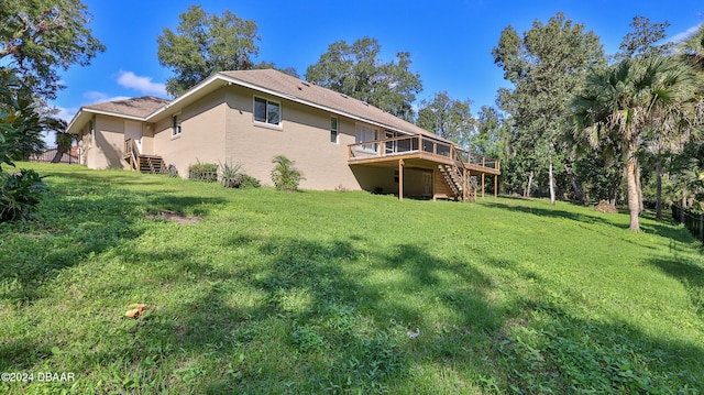 rear view of house with a yard and a deck