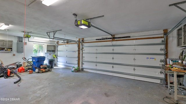 garage featuring electric panel and a garage door opener