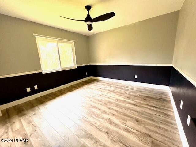 unfurnished room featuring light hardwood / wood-style flooring and ceiling fan