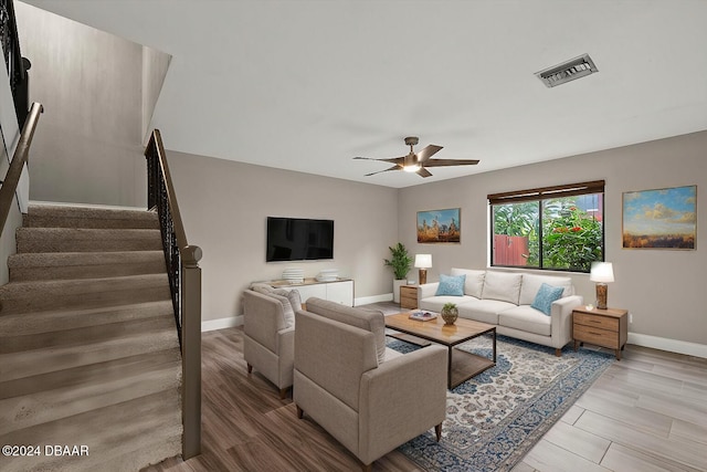 living room featuring light hardwood / wood-style floors and ceiling fan