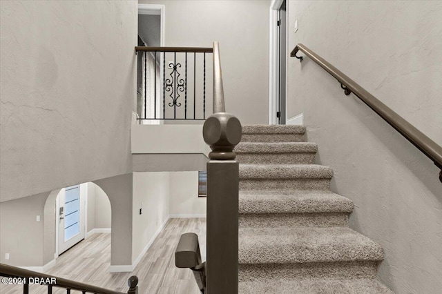 stairs featuring hardwood / wood-style flooring