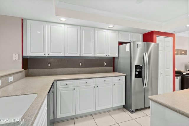 kitchen with white cabinets, stainless steel refrigerator with ice dispenser, decorative backsplash, ornamental molding, and light tile patterned flooring