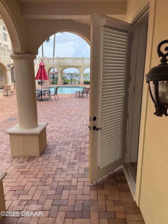 5090 Riverside Dr Unit 108, Port Orange, FL 32127 - view of patio with a community pool