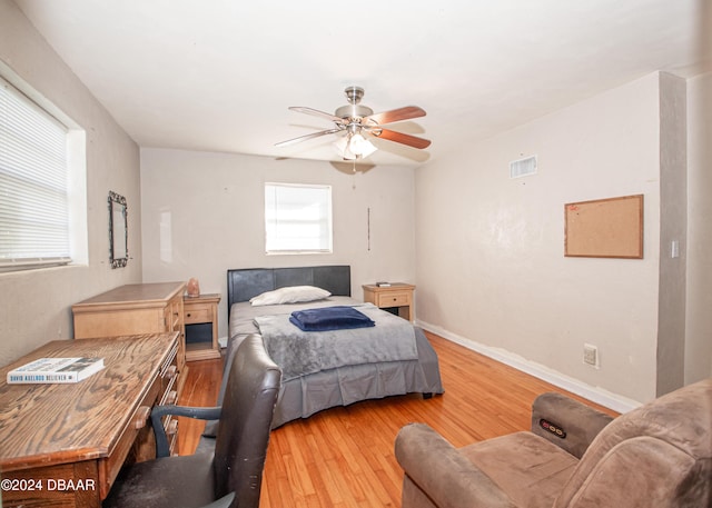 bedroom with light hardwood / wood-style flooring and ceiling fan