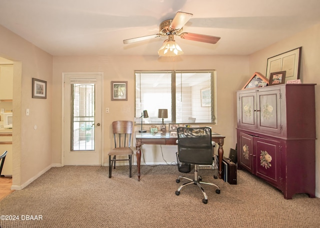 carpeted home office with ceiling fan