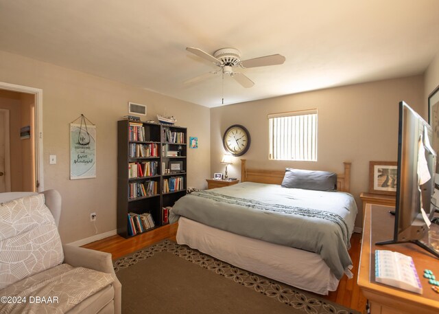 bedroom with ceiling fan and wood-type flooring