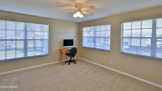 unfurnished office featuring ceiling fan and light carpet