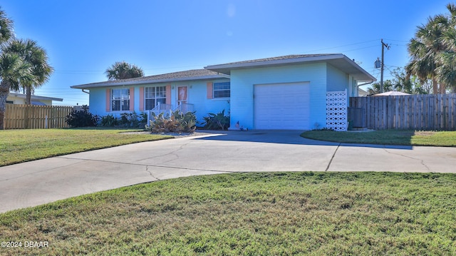 ranch-style home featuring a garage and a front lawn