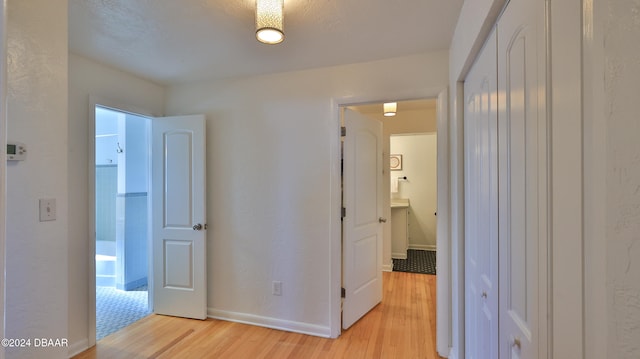 corridor with light hardwood / wood-style flooring