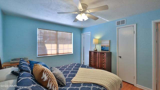 bedroom with ceiling fan and hardwood / wood-style floors