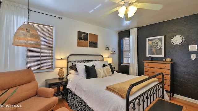 bedroom featuring hardwood / wood-style flooring and ceiling fan