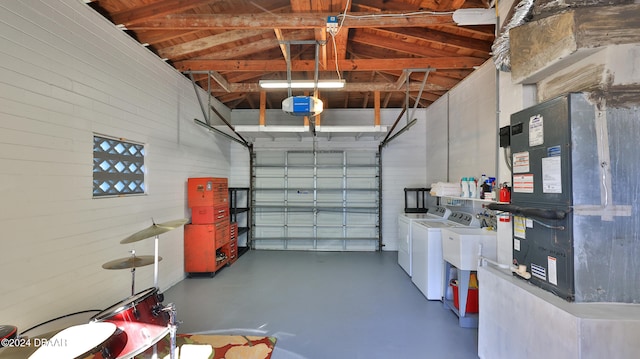 garage featuring separate washer and dryer and heating unit