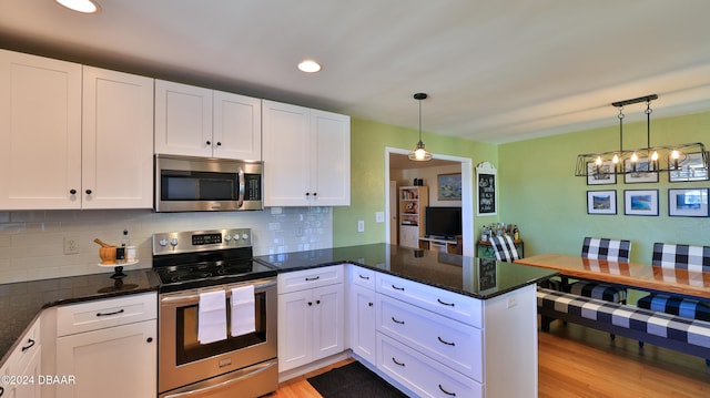 kitchen with stainless steel appliances and white cabinetry