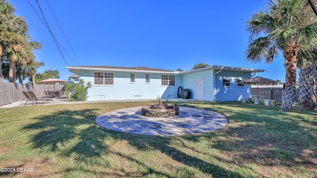 back of house featuring a yard and a patio