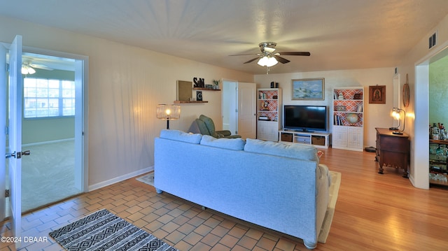 living room featuring ceiling fan and wood-type flooring