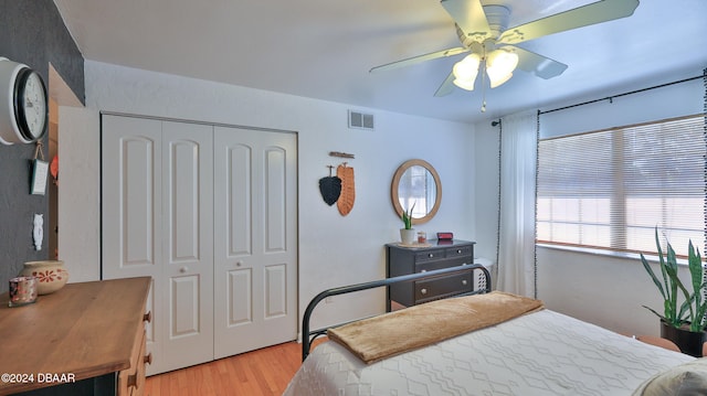 bedroom featuring ceiling fan, a closet, and light wood-type flooring