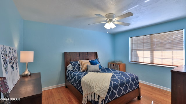 bedroom featuring hardwood / wood-style flooring and ceiling fan