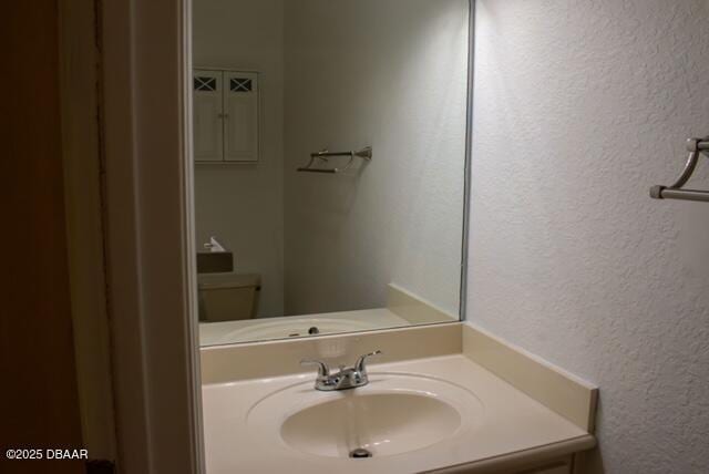 594 Marisol Dr, New Smyrna Beach, FL 32168 - bathroom with a textured wall and vanity