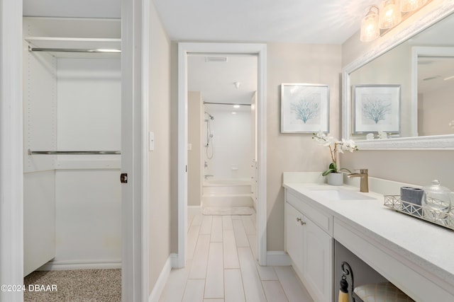 bathroom featuring visible vents, vanity, shower / bath combination, and baseboards