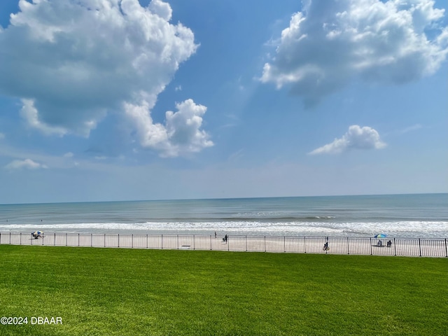 property view of water with a beach view and fence