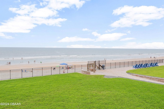 view of water feature with a view of the beach and fence