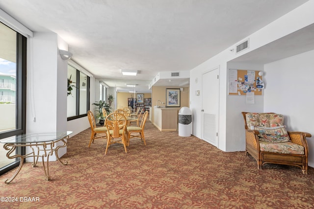 dining space featuring visible vents and carpet flooring