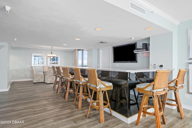 bar featuring visible vents, baseboards, and wood finished floors