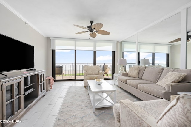 living area with wood finish floors, a healthy amount of sunlight, ceiling fan, and floor to ceiling windows