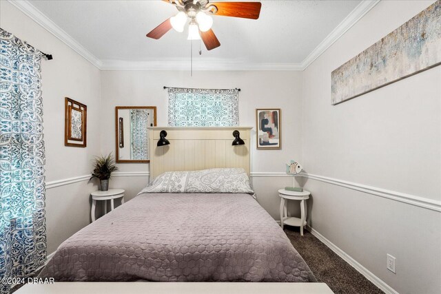 carpeted bedroom with ornamental molding and ceiling fan