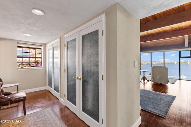761 Marina Point Dr Unit 7610, Daytona Beach, FL 32114 - corridor featuring baseboards, french doors, beamed ceiling, wooden ceiling, and wood finished floors