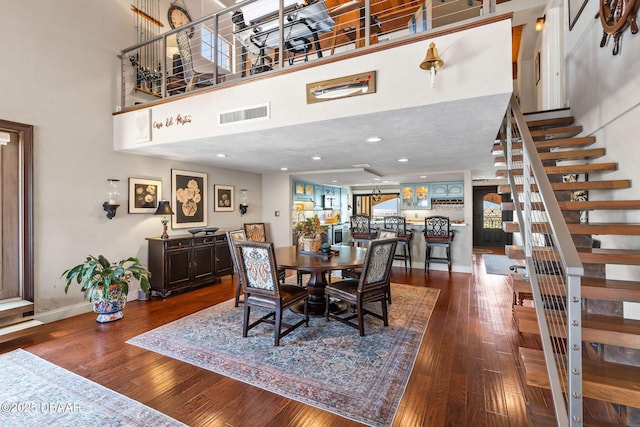 761 Marina Point Dr Unit 7610, Daytona Beach, FL 32114 - dining area featuring stairway, visible vents, a high ceiling, and dark wood finished floors