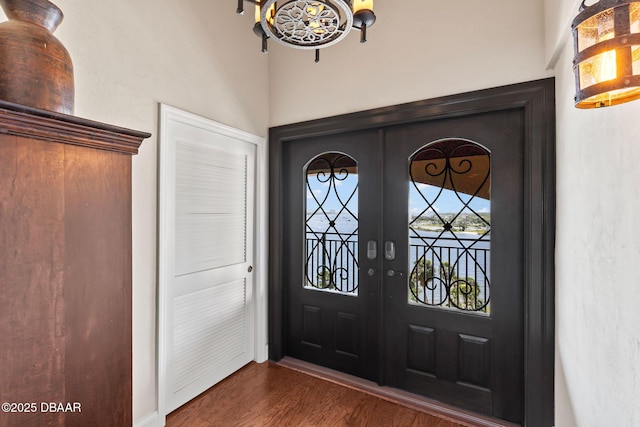 761 Marina Point Dr Unit 7610, Daytona Beach, FL 32114 - entrance foyer with dark wood-type flooring, french doors, and an inviting chandelier