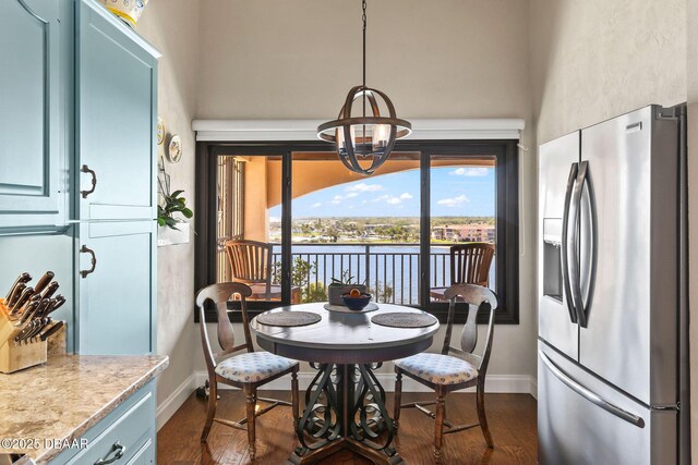 761 Marina Point Dr Unit 7610, Daytona Beach, FL 32114 - dining space with baseboards, a notable chandelier, a towering ceiling, and dark wood finished floors