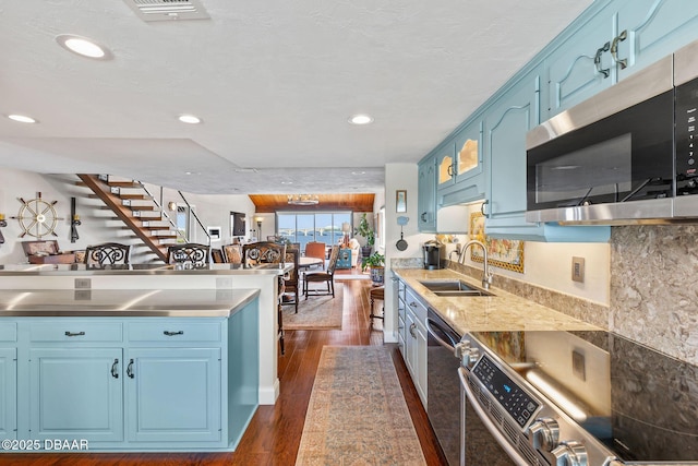 761 Marina Point Dr Unit 7610, Daytona Beach, FL 32114 - kitchen featuring blue cabinets, dark wood-style floors, a sink, and appliances with stainless steel finishes
