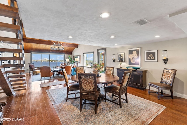 761 Marina Point Dr Unit 7610, Daytona Beach, FL 32114 - dining area featuring visible vents, a textured ceiling, wood finished floors, and lofted ceiling