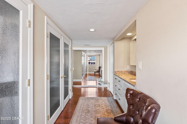761 Marina Point Dr Unit 7610, Daytona Beach, FL 32114 - hallway featuring dark wood-style flooring and baseboards