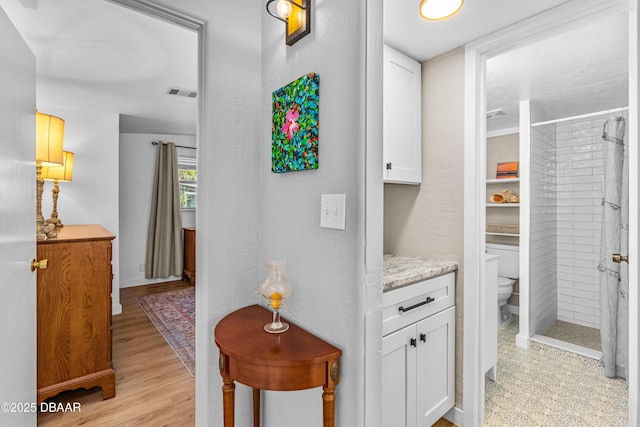 23 Briggs Dr, Ormond Beach, FL 32176 - hallway with light wood finished floors and baseboards