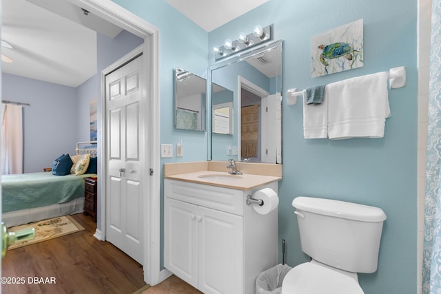 5300 S Atlantic Ave Unit 16-505, New Smyrna Beach, FL 32169 - ensuite bathroom featuring toilet, wood finished floors, visible vents, ensuite bath, and vanity