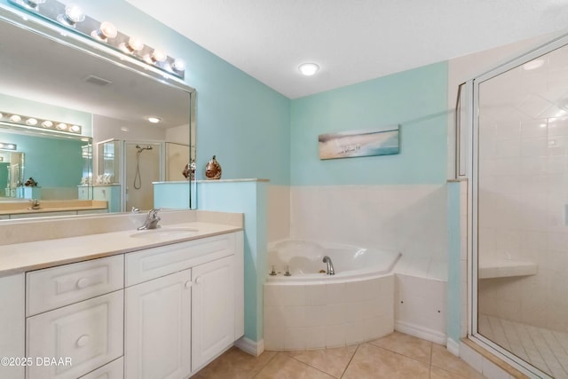 5300 S Atlantic Ave Unit 16-505, New Smyrna Beach, FL 32169 - bathroom featuring a stall shower, tile patterned flooring, a garden tub, and vanity
