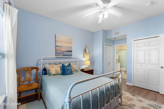 5300 S Atlantic Ave Unit 16-505, New Smyrna Beach, FL 32169 - bedroom with ceiling fan, connected bathroom, visible vents, and wood finished floors