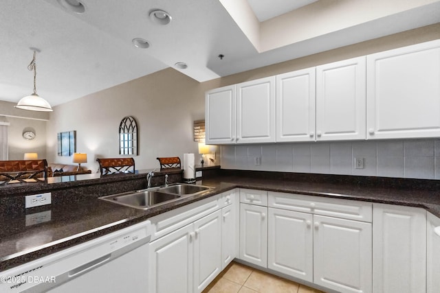 5300 S Atlantic Ave Unit 16-505, New Smyrna Beach, FL 32169 - kitchen featuring a sink, white cabinetry, white dishwasher, and backsplash