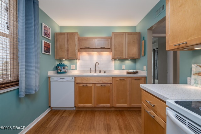 3370 Ocean Shore Blvd Unit 202B, Ormond Beach, FL 32176 - kitchen with white dishwasher, light countertops, light wood-type flooring, and decorative backsplash