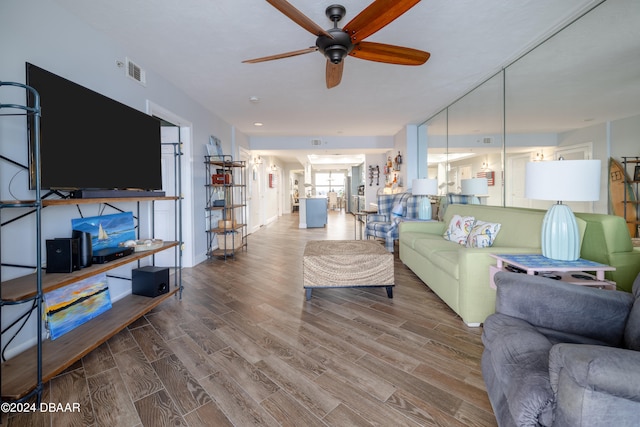 living room with hardwood / wood-style floors and ceiling fan