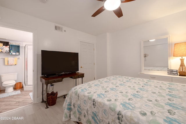 bedroom with ceiling fan, light hardwood / wood-style floors, and ensuite bath