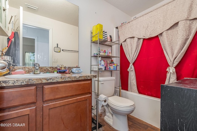 full bathroom featuring hardwood / wood-style floors, toilet, vanity, and shower / tub combo with curtain